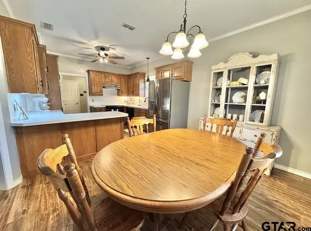 a dining room with a table and chairs