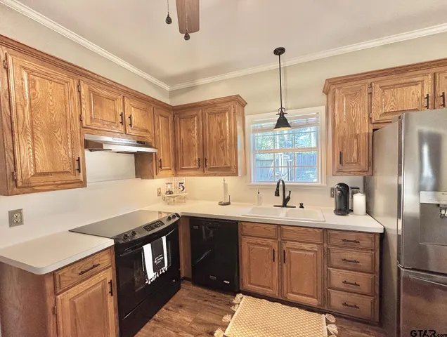 a kitchen with a sink stove and cabinets