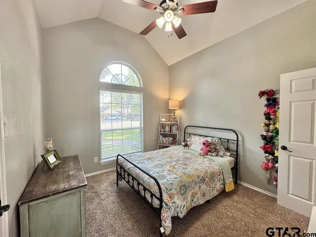 a bedroom with a bed and window