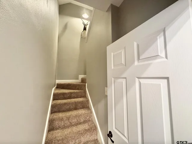 a view of staircase with white walls