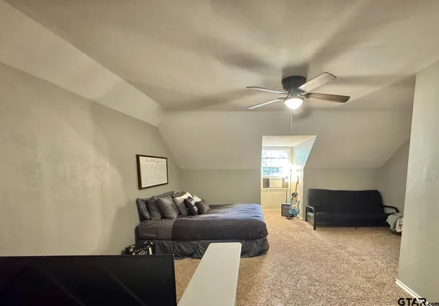 a living room with furniture and a ceiling fan