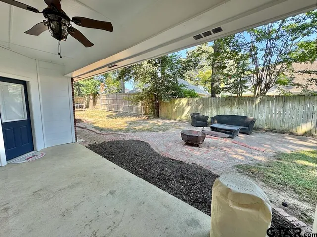 a view of a porch with furniture and a yard