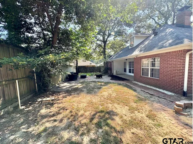 a view of a house with backyard and sitting area