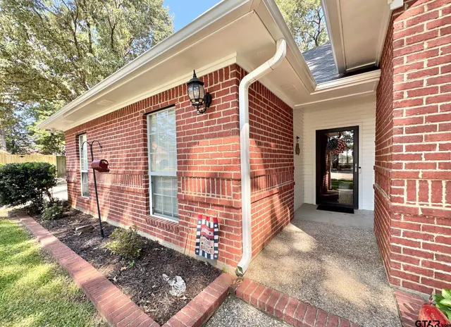 a backyard of a house with barbeque oven and table