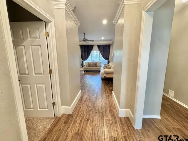 a view of hallway with wooden floor and staircase
