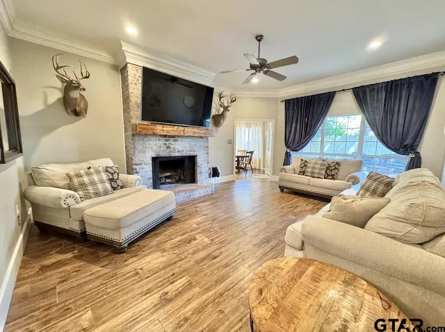 a living room with furniture fireplace and a flat screen tv