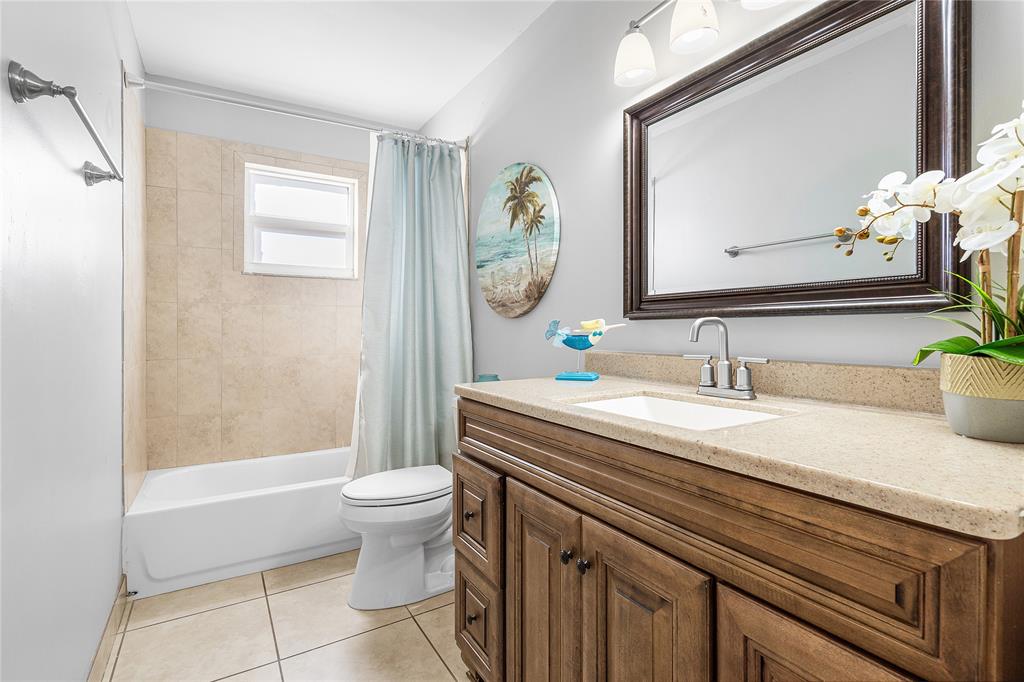 9661 Carousel Circle South Boca Raton, FL 33434 - Photo 15 of 25 a bathroom with a granite countertop sink a toilet and a mirror