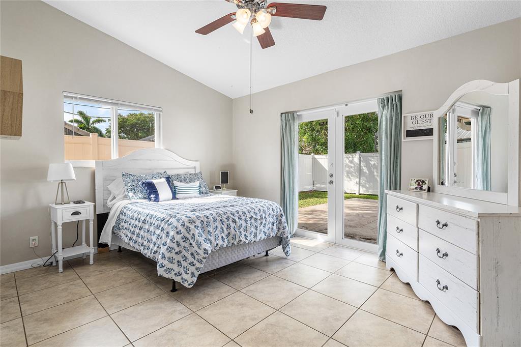 9661 Carousel Circle South Boca Raton, FL 33434 - Photo 16 of 25 a bedroom with a large bed and a window