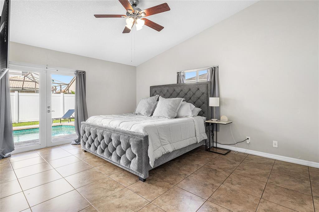 9661 Carousel Circle South Boca Raton, FL 33434 - Photo 17 of 25 a bedroom with a bed and large windows