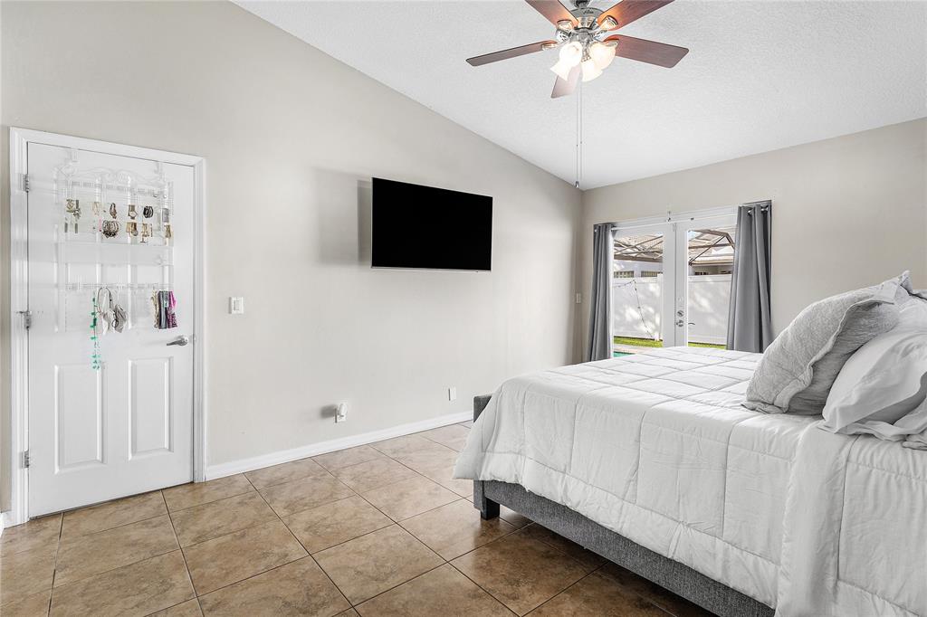 9661 Carousel Circle South Boca Raton, FL 33434 - Photo 18 of 25 a bedroom with a bed and a flat screen tv