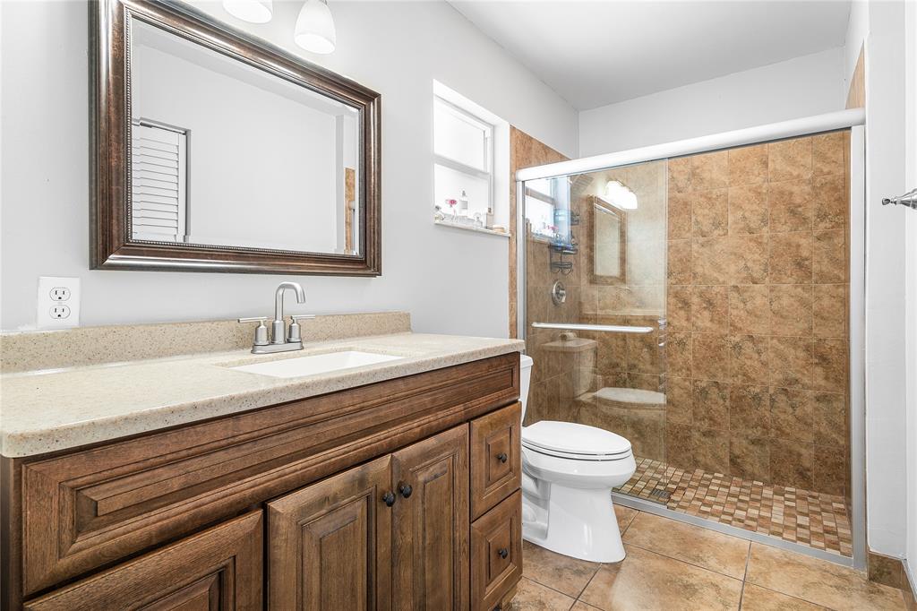 9661 Carousel Circle South Boca Raton, FL 33434 - Photo 19 of 25 a bathroom with a granite countertop sink a toilet and a mirror
