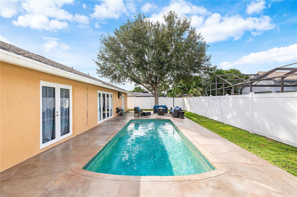9661 Carousel Circle South Boca Raton, FL 33434 - Photo 2 of 25 a view of a backyard with swimming pool