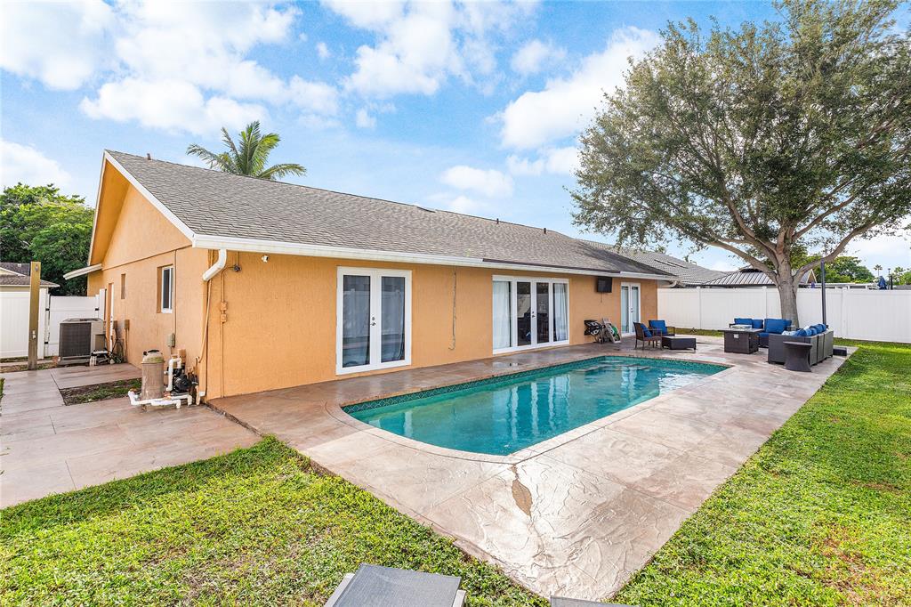 9661 Carousel Circle South Boca Raton, FL 33434 - Photo 22 of 25 a view of house with swimming pool outdoor seating