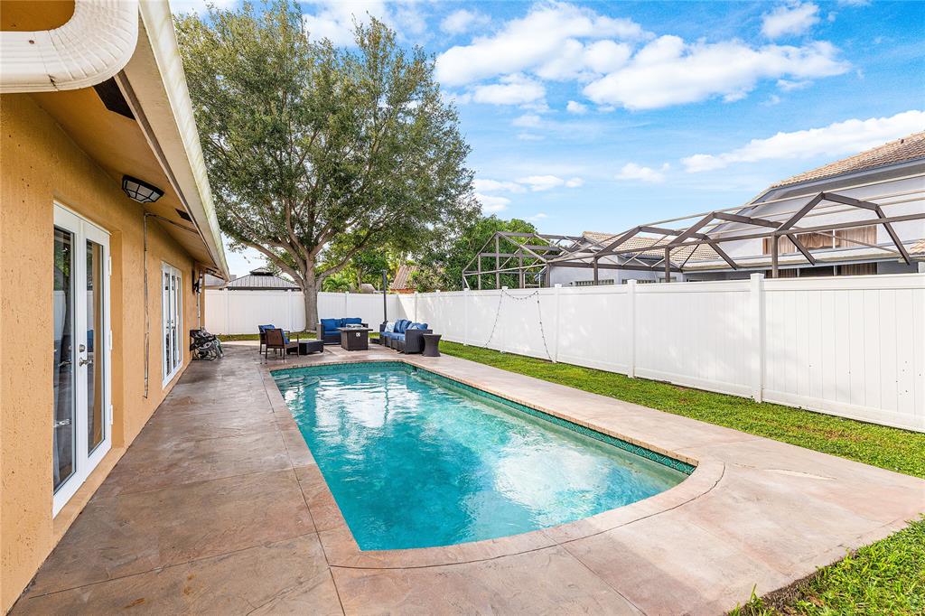 9661 Carousel Circle South Boca Raton, FL 33434 - Photo 23 of 25 a view of a swimming pool with a lounge chairs