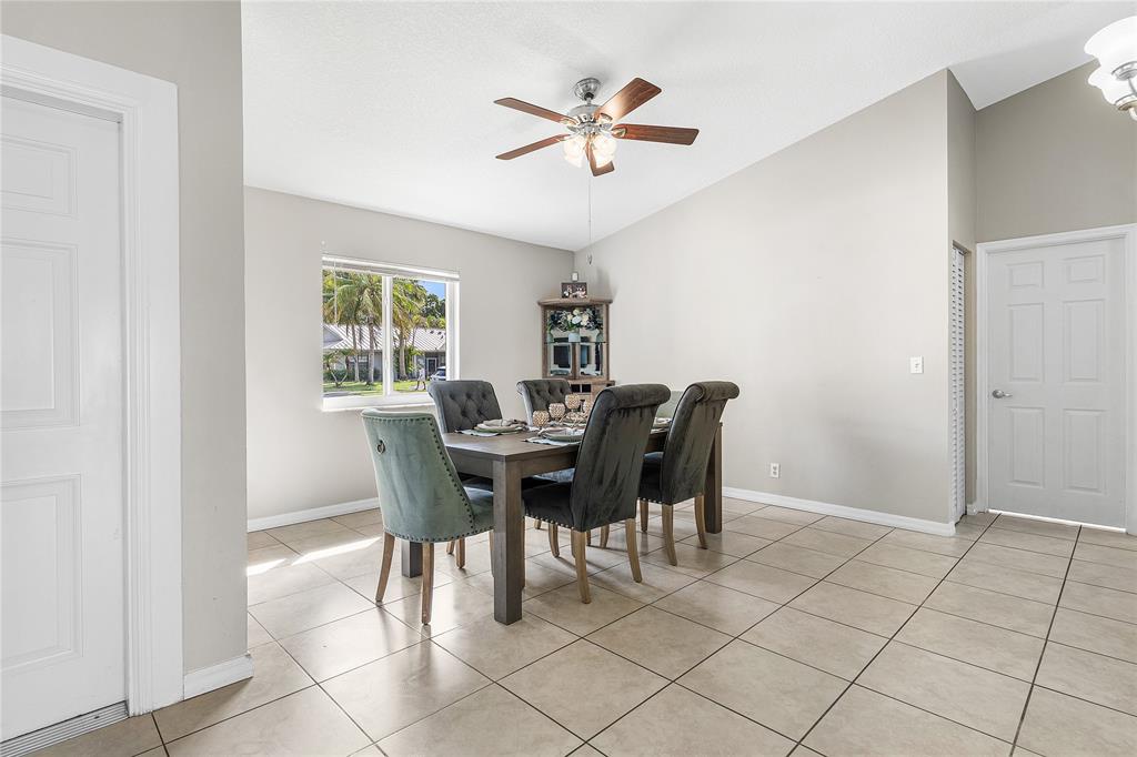 9661 Carousel Circle South Boca Raton, FL 33434 - Photo 5 of 25 a view of a dining room with furniture and a window