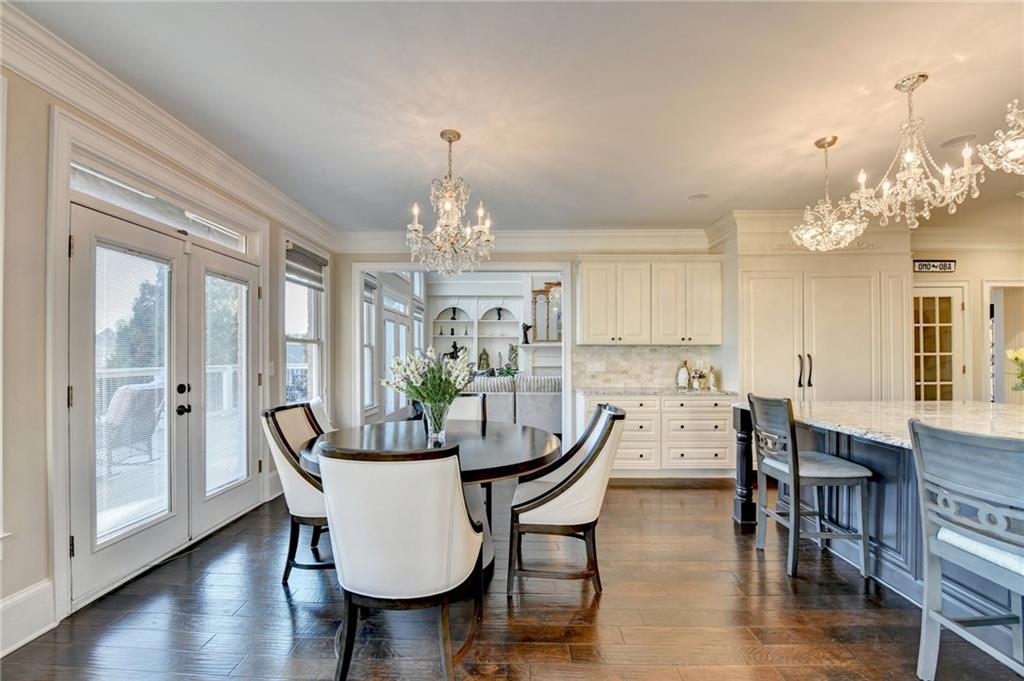 8360 Kenningston Way Duluth, GA 30097 - Photo 18 of 54 a view of a dining room with furniture wooden floor and chandelier