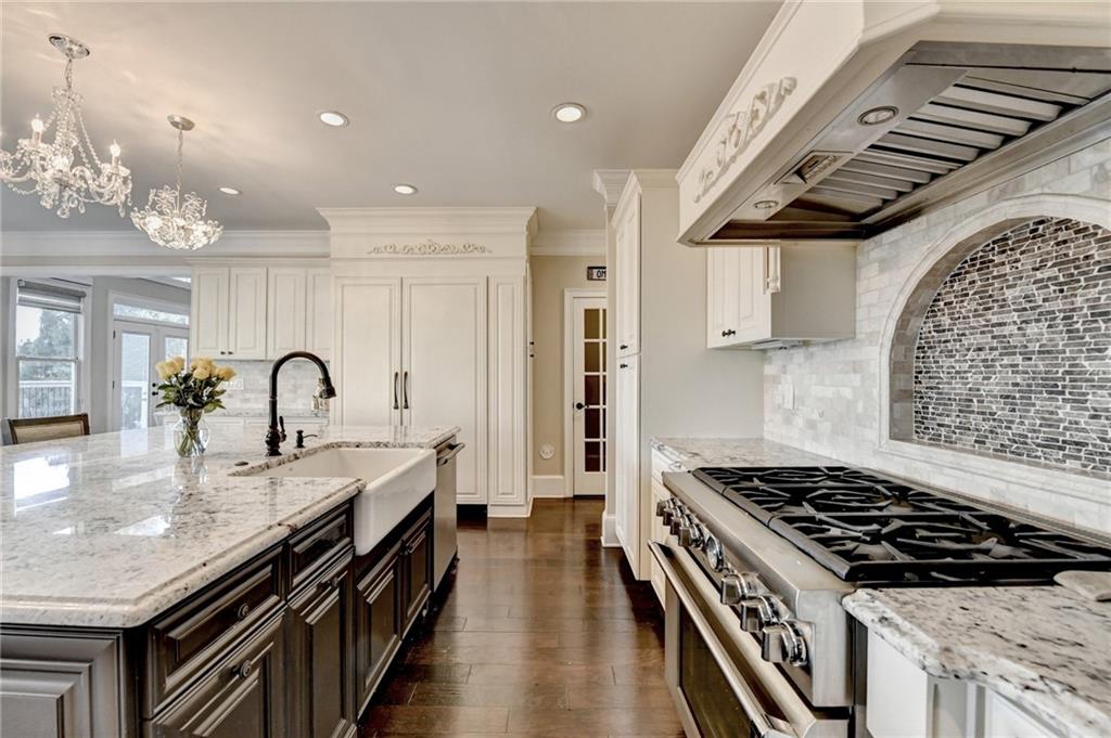 8360 Kenningston Way Duluth, GA 30097 - Photo 19 of 54 a kitchen with granite countertop a stove and a sink