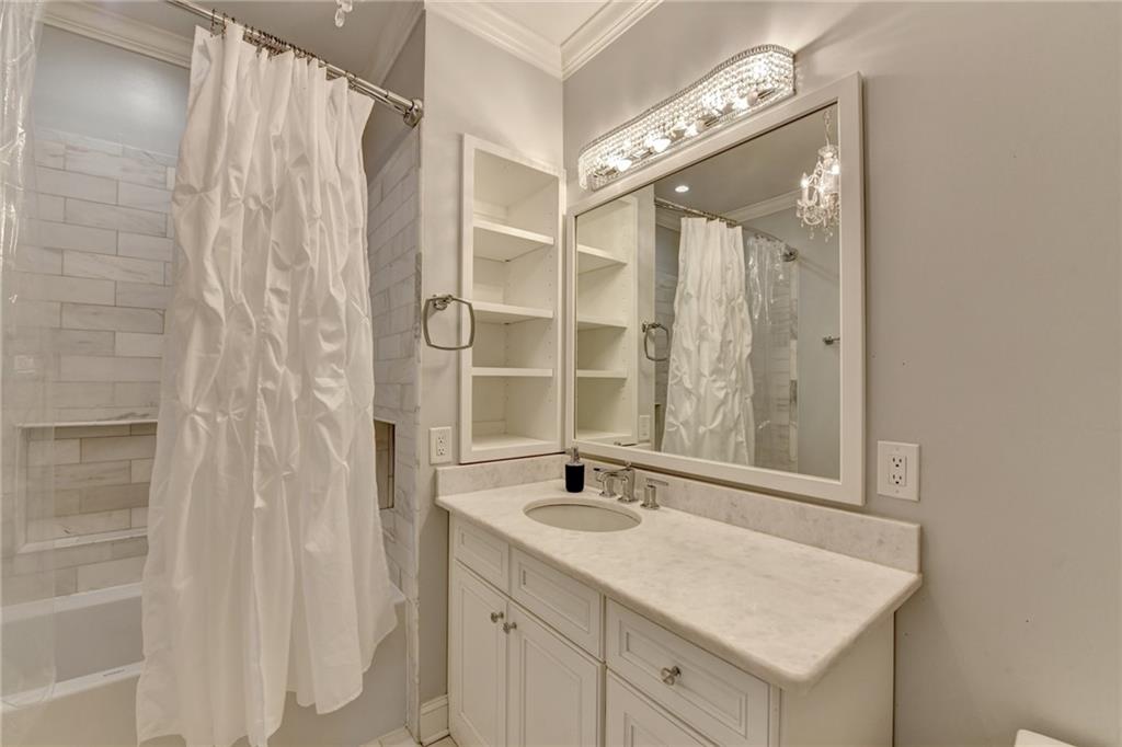 8360 Kenningston Way Duluth, GA 30097 - Photo 32 of 54 a bathroom with a sink a vanity and a mirror