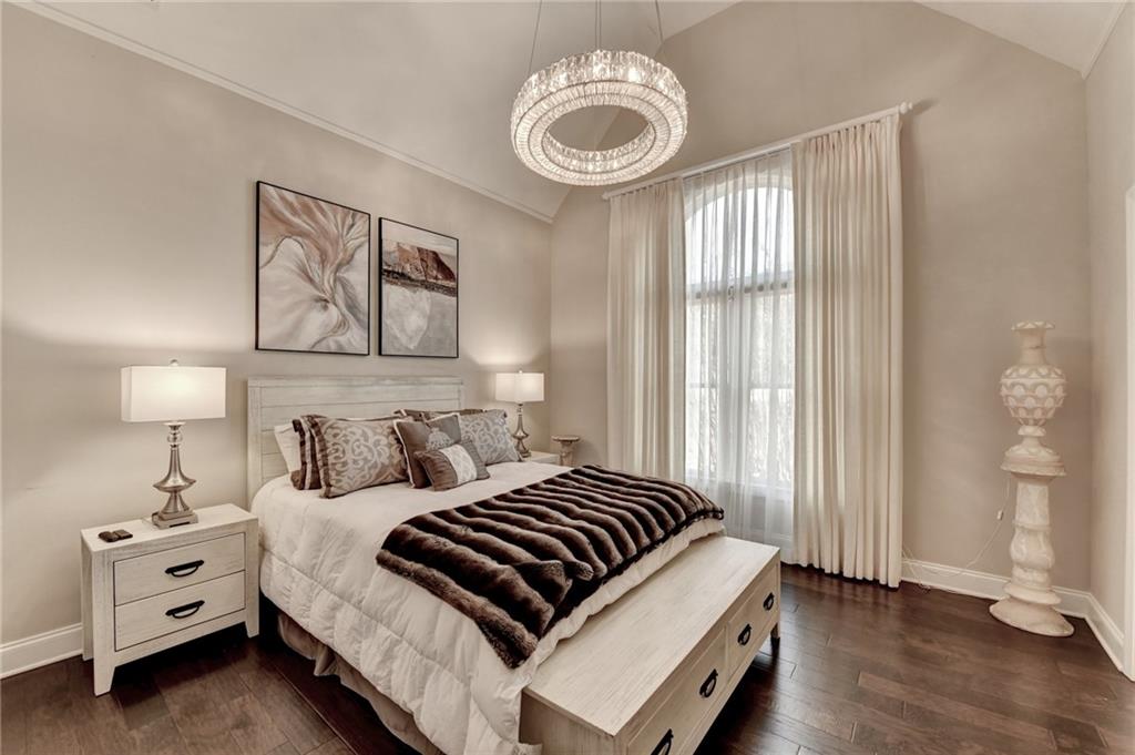 8360 Kenningston Way Duluth, GA 30097 - Photo 33 of 54 a bedroom with a bed and a chandelier