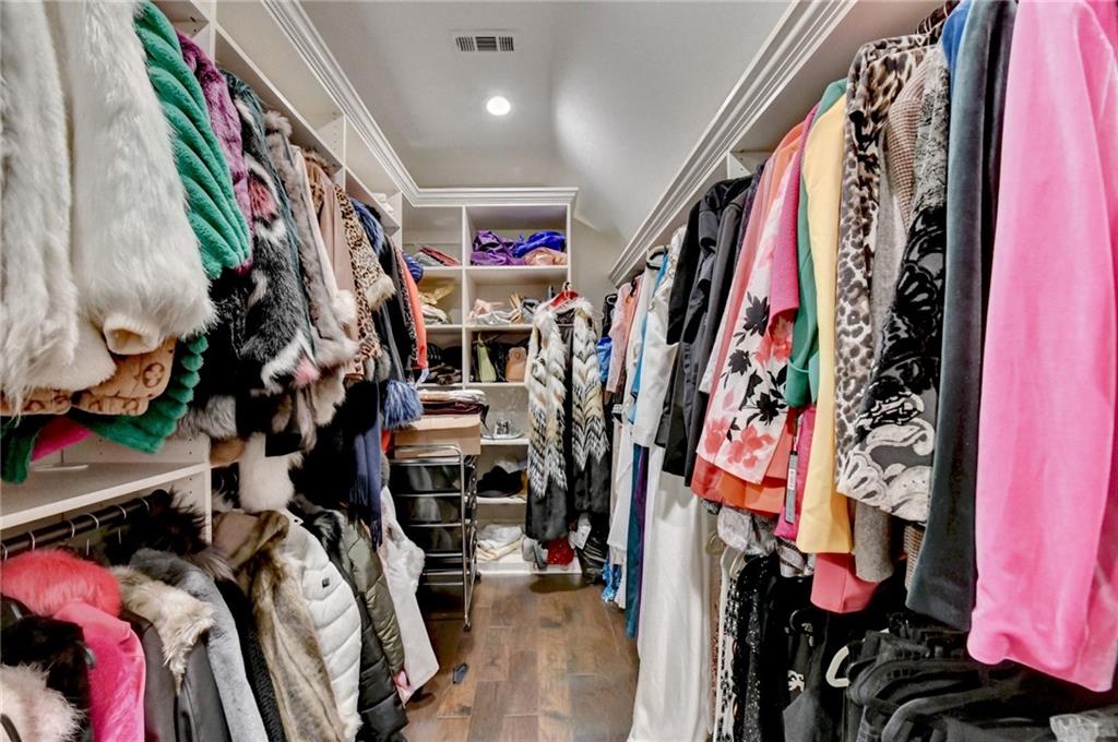 8360 Kenningston Way Duluth, GA 30097 - Photo 38 of 54 a view of walk in closet with clothes and shoes