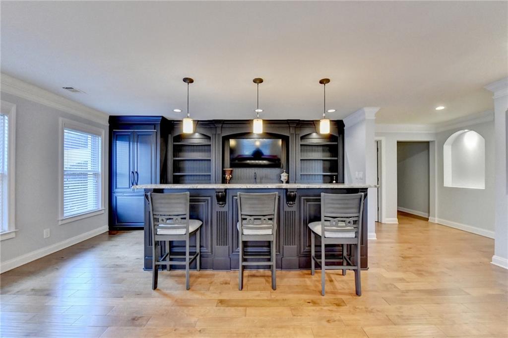 8360 Kenningston Way Duluth, GA 30097 - Photo 40 of 54 a kitchen with stainless steel appliances kitchen island granite countertop a table and chairs in it
