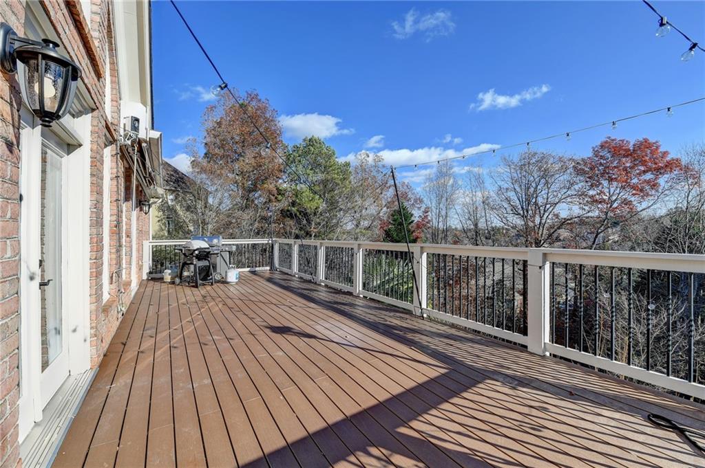 8360 Kenningston Way Duluth, GA 30097 - Photo 8 of 54 a view of balcony with wooden floor and fence