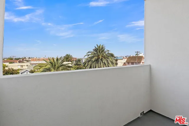 a view of a balcony with an outdoor space and seating