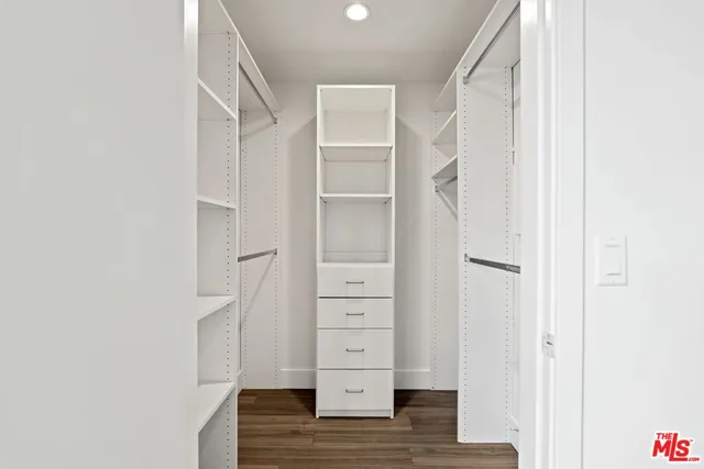 a view of walk in closet with empty racks