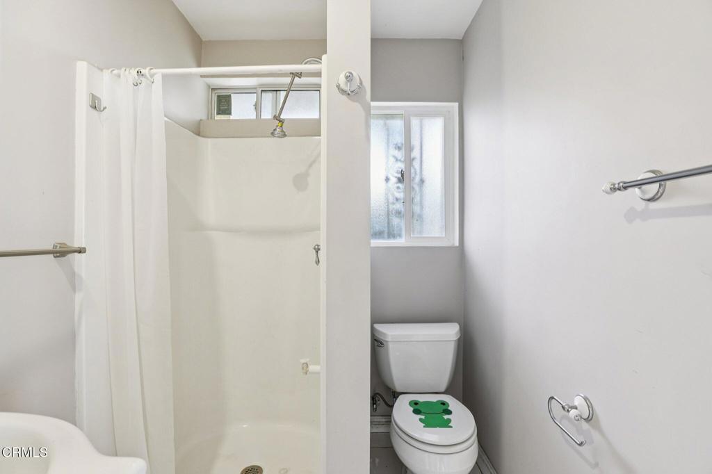 10856 Topeka Drive Porter Ranch, CA 91326 - Photo 12 of 40 a white toilet sitting next to a bathroom sink