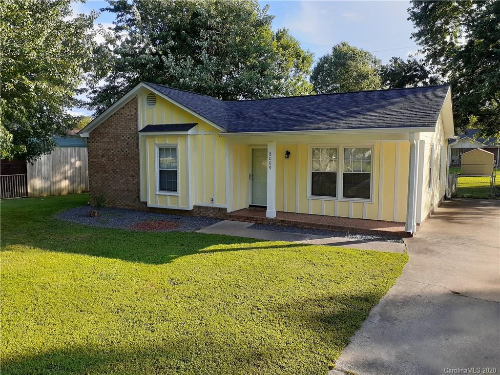 a view of a house with pool and yard