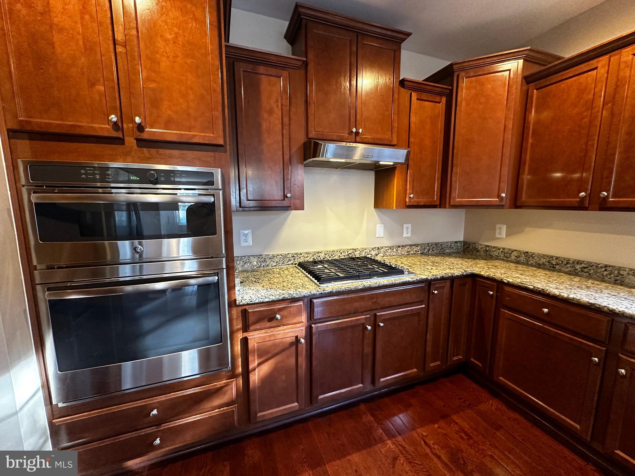 15165 Santander Drive Gainesville, VA 20155 - Photo 13 of 35 a kitchen with granite countertop a stove and a sink