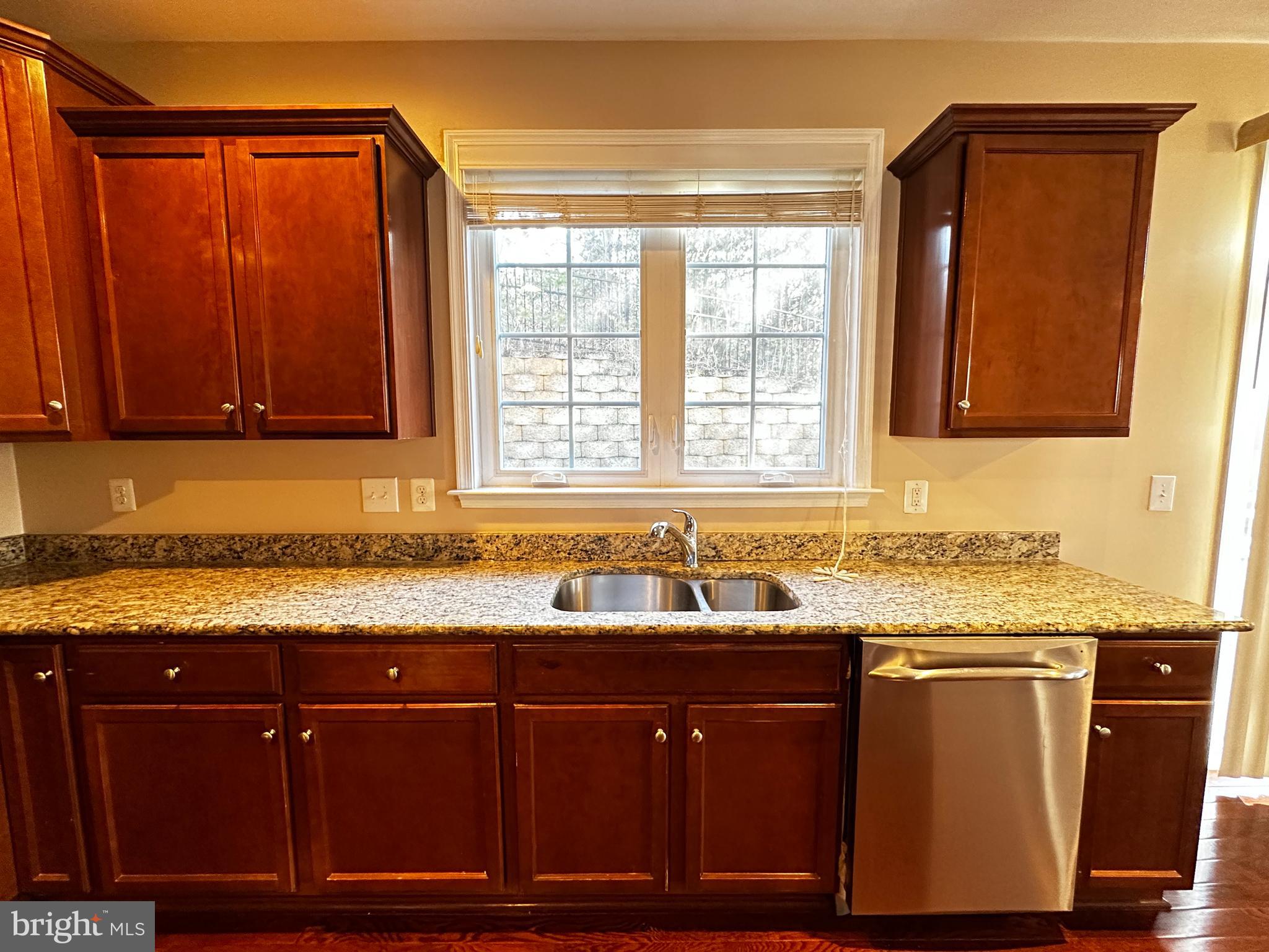15165 Santander Drive Gainesville, VA 20155 - Photo 14 of 35 a kitchen with granite countertop cabinets sink and window