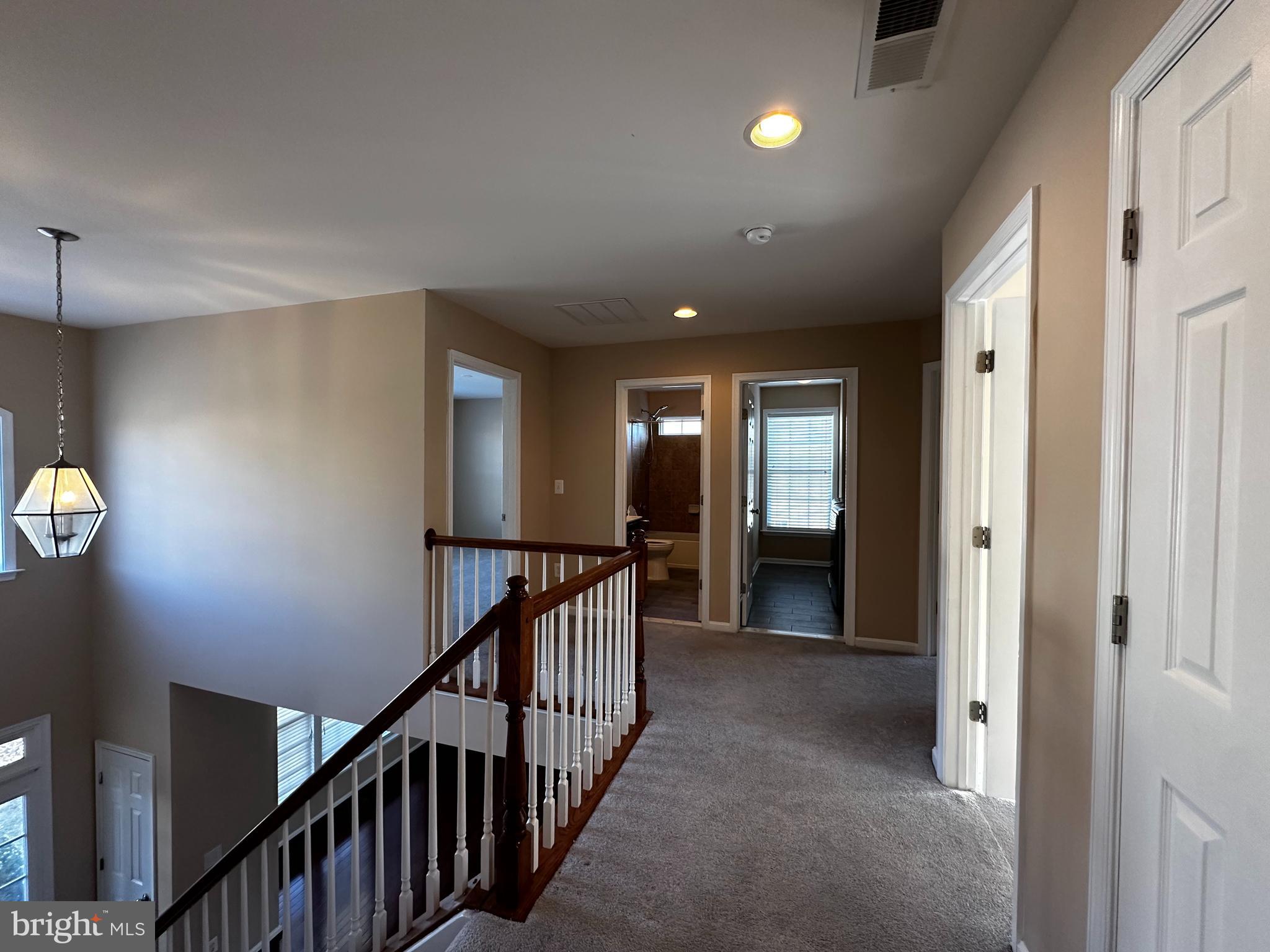 15165 Santander Drive Gainesville, VA 20155 - Photo 25 of 35 a view of a hallway with wooden floor and stairs