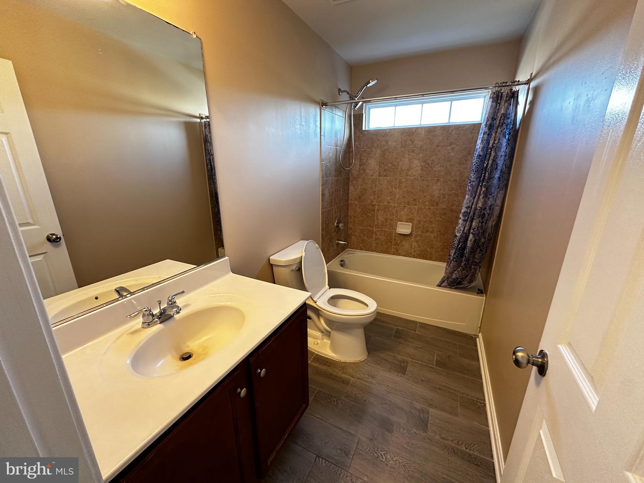 15165 Santander Drive Gainesville, VA 20155 - Photo 27 of 35 a bathroom with a sink a toilet and shower