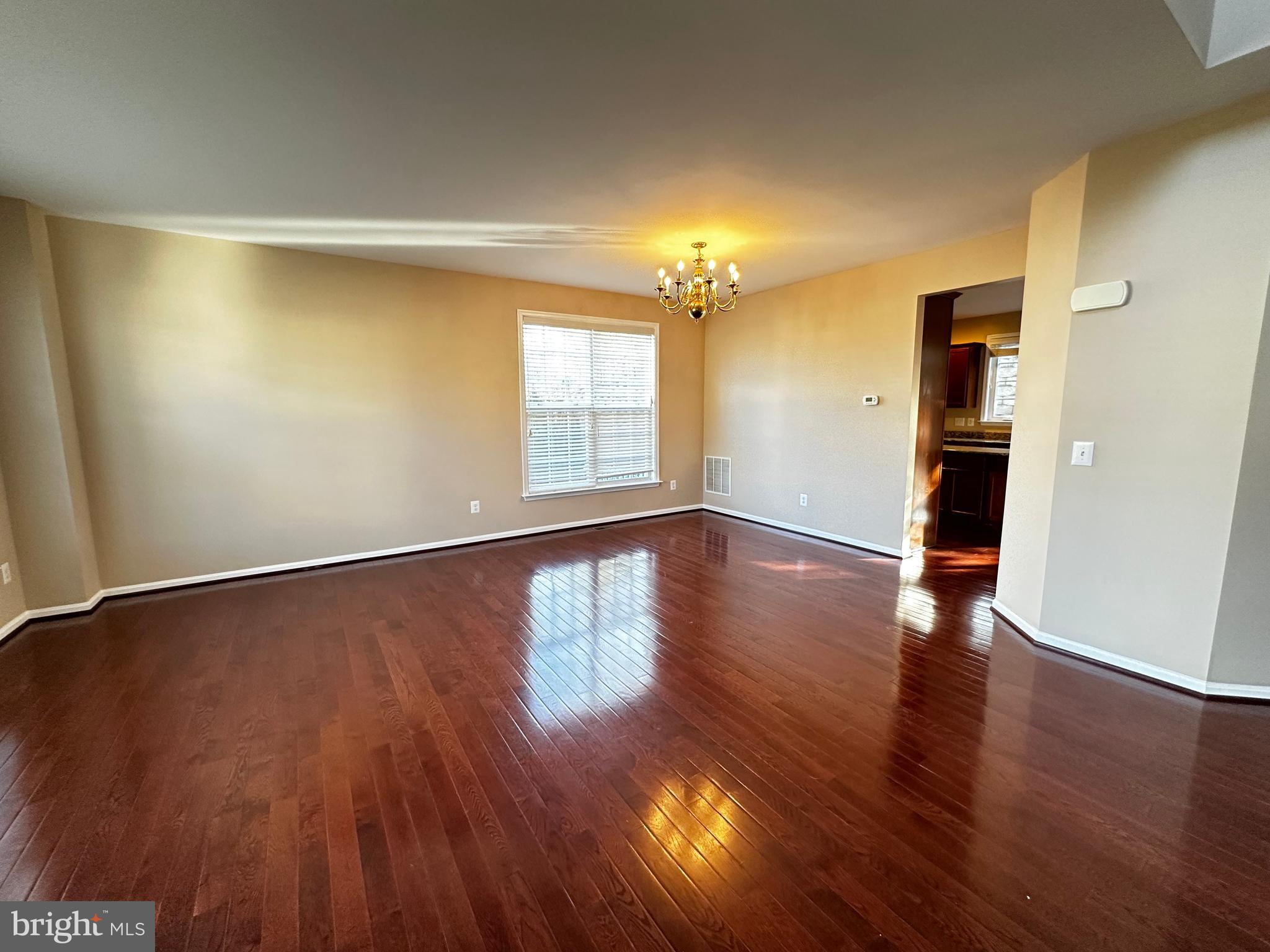 15165 Santander Drive Gainesville, VA 20155 - Photo 7 of 35 an empty room with wooden floor and windows