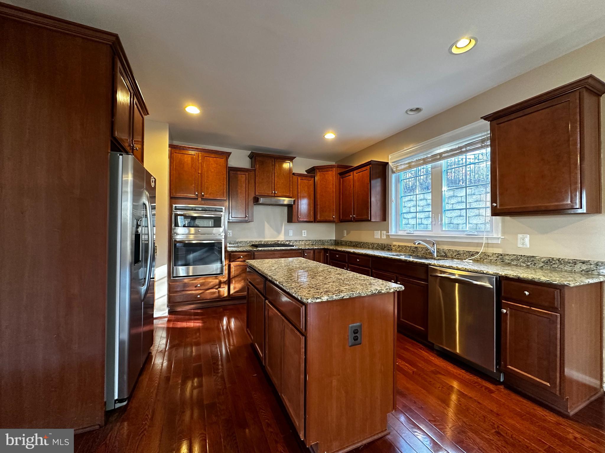 15165 Santander Drive Gainesville, VA 20155 - Photo 9 of 35 a kitchen with stainless steel appliances granite countertop a stove a sink and a microwave