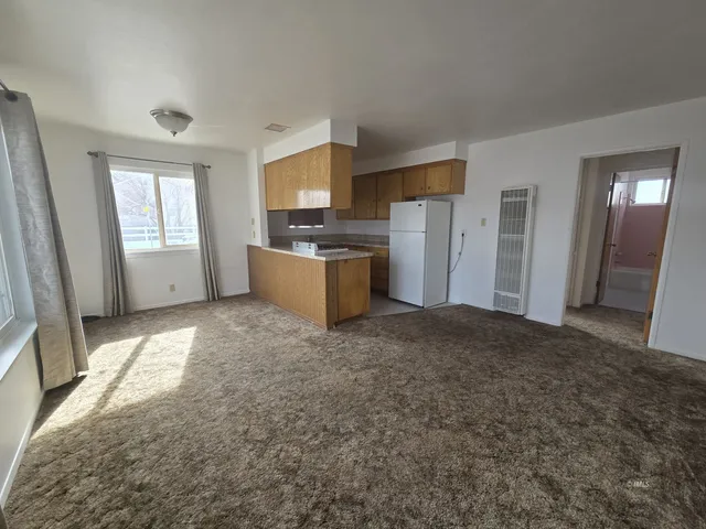 a kitchen with a stove and refrigerator