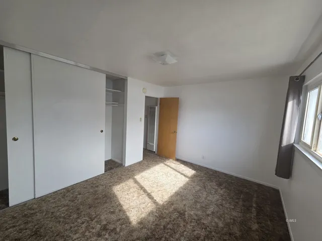 a view of an empty room and window