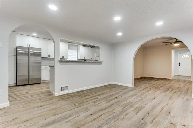a view of a kitchen with a sink and wooden floor