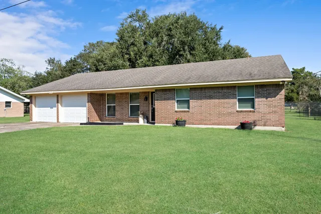 a front view of house with yard and green space