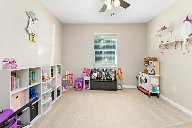 a bedroom with baby toys and a chandelier