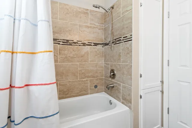 a bathroom with a bathtub and a shower