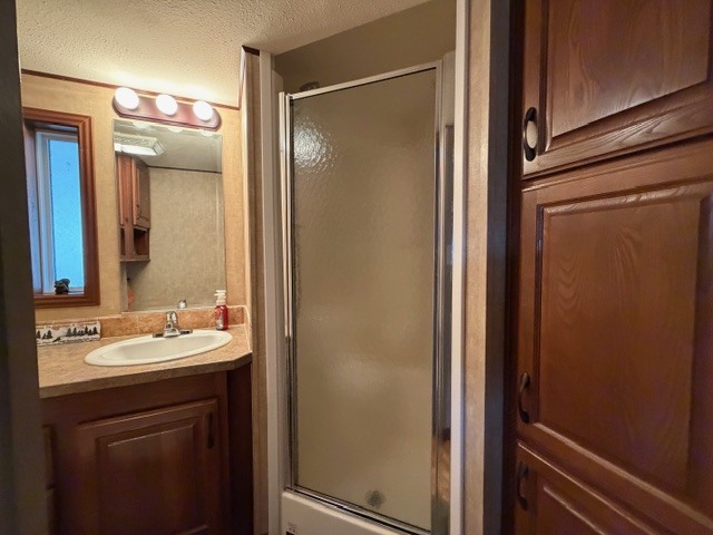 2795 East 28th Road Marseilles, IL 61341 - Photo 25 of 78 a bathroom with a sink a mirror a vanity and a shower