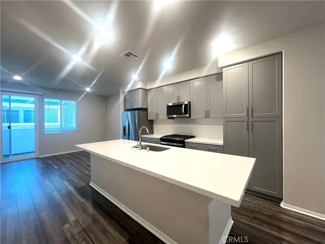a kitchen with a sink a stove and refrigerator