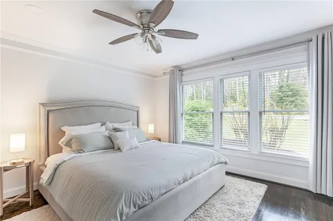 a bedroom with a large bed and a window