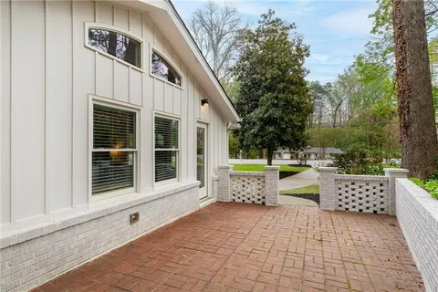 a view of a chairs and table in the back yard of the house