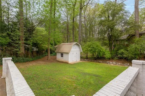 a view of a backyard with large trees