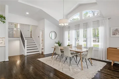 a view of a dining room with furniture and wooden floor