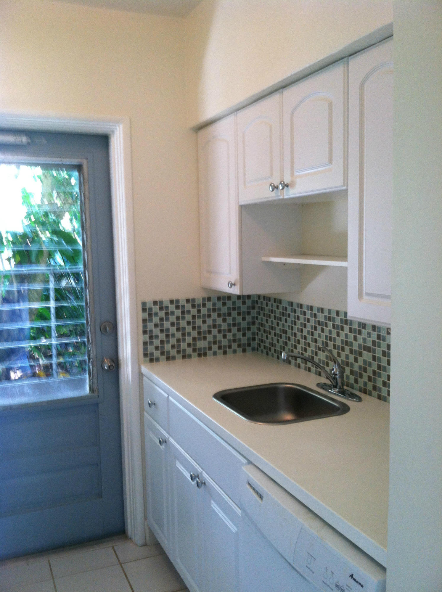 917 Bucida Road, Unit 3 Delray Beach, FL 33483 - Photo 3 of 22 a kitchen with a sink and cabinets