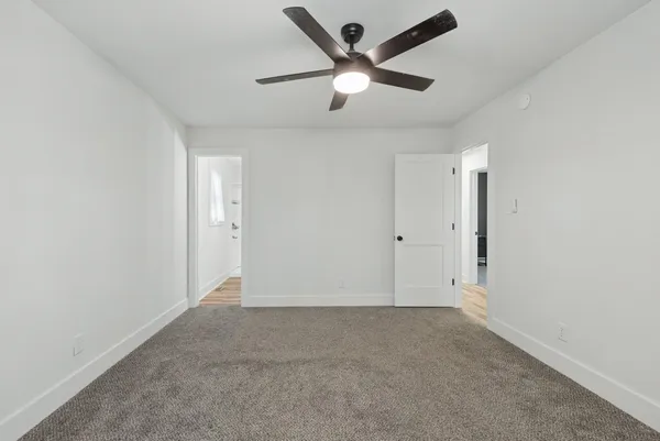 an empty room with ceiling fan